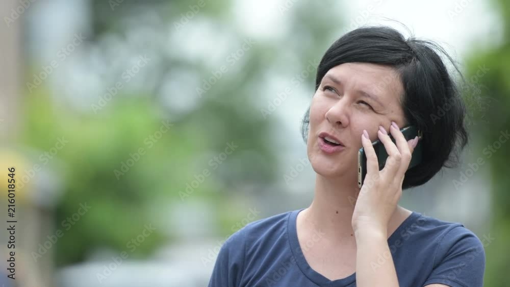 Happy beautiful woman talking on the phone outdoors Happy beautiful woman talking on the phone outdoors