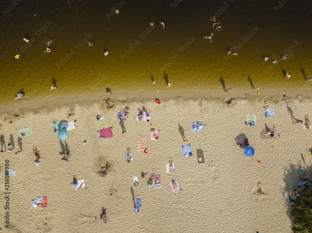 People enjoying the beach and swimming in the sea, aerial view