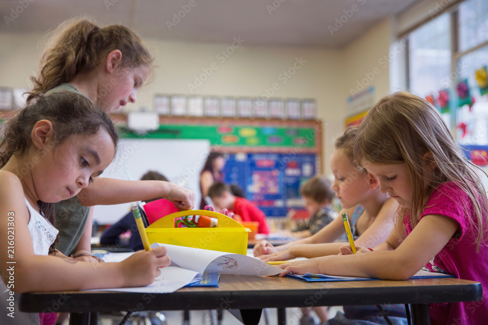 © Kinzie+Riehm - Children writing at a desk in a kindergarten classroom.