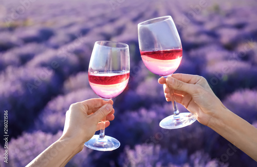 Fototapeta Naklejka Na Ścianę i Meble -  People with glasses of wine in lavender field