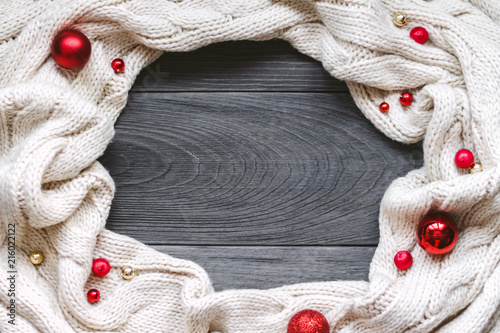 Christmas composition. Cozy knitted blanket on grey wooden background. Christmas, winter, new year concept. Flat lay, top view, copy space.