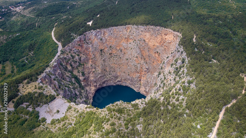 Red Lake (Croatian: Crveno jezero) is a collapse doline (collapse sinkhole) containing a karst lake close to Imotski, Croatia. It is 530 metres deep, thus it is the largest collapse doline in Europe. photo