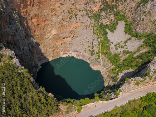 Red Lake (Croatian: Crveno jezero) is a collapse doline (collapse sinkhole) containing a karst lake close to Imotski, Croatia. It is 530 metres deep, thus it is the largest collapse doline in Europe.