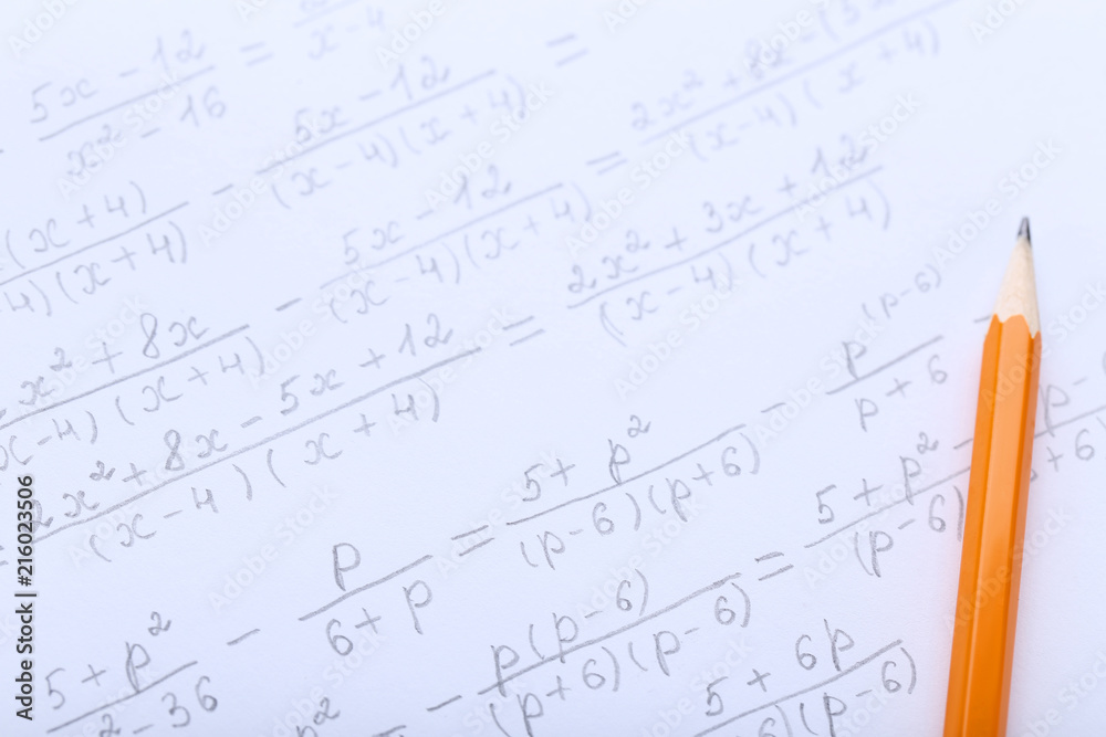 Exercise book with maths formulas and pencil Exercise book with maths formulas and pencil