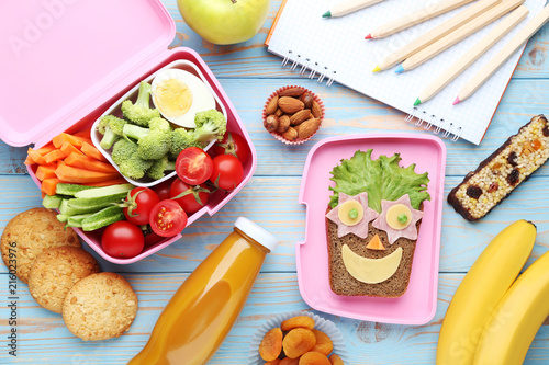 School lunch box with vegetables and fruits on blue wooden table