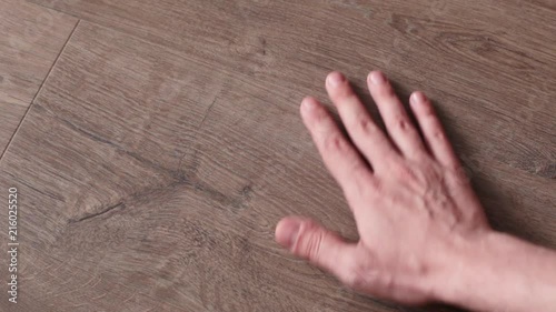 man touches wood textured surface
