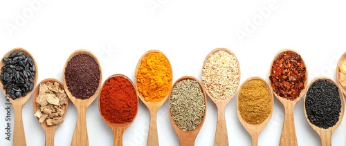 Obraz  z motywem Composition with different aromatic spices in wooden spoons on white background