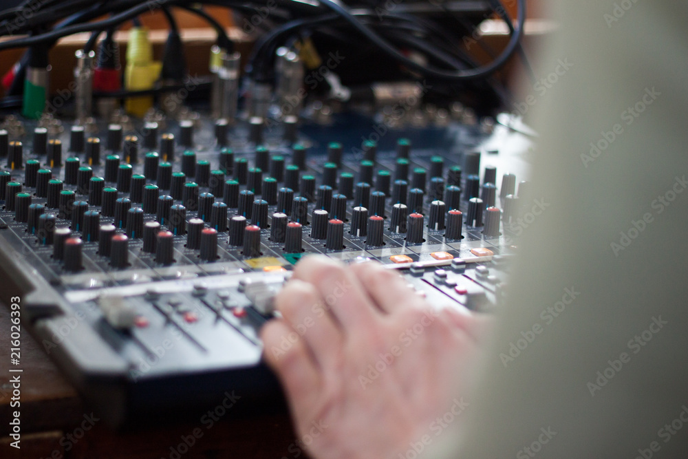 Sound operator during his work with sound control system