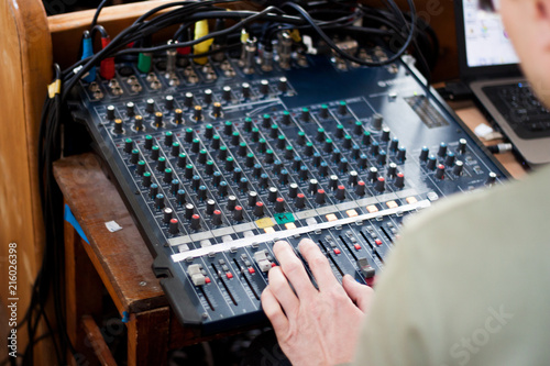 Sound operator during his work with sound control system