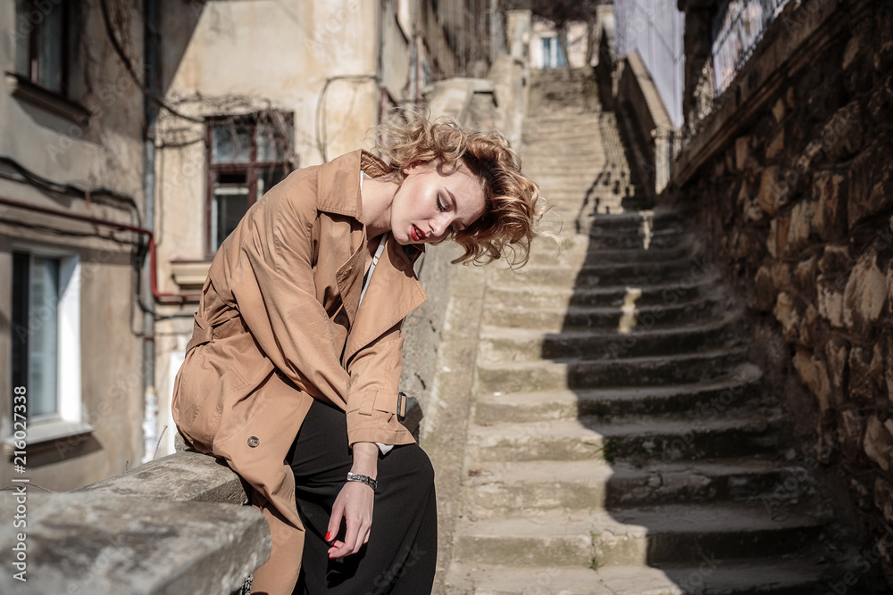 fashion woman portrait of young pretty trendy girl posing at the city in Europe,spring street fashion. laughing and smiling portrait. fashion woman portrait of young pretty trendy girl posing at the city in Europe,spring street fashion. laughing and smiling portrait.