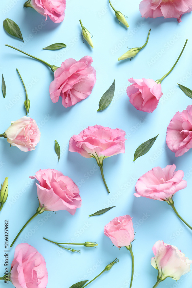 Flat lay composition with beautiful Eustoma flowers on color background