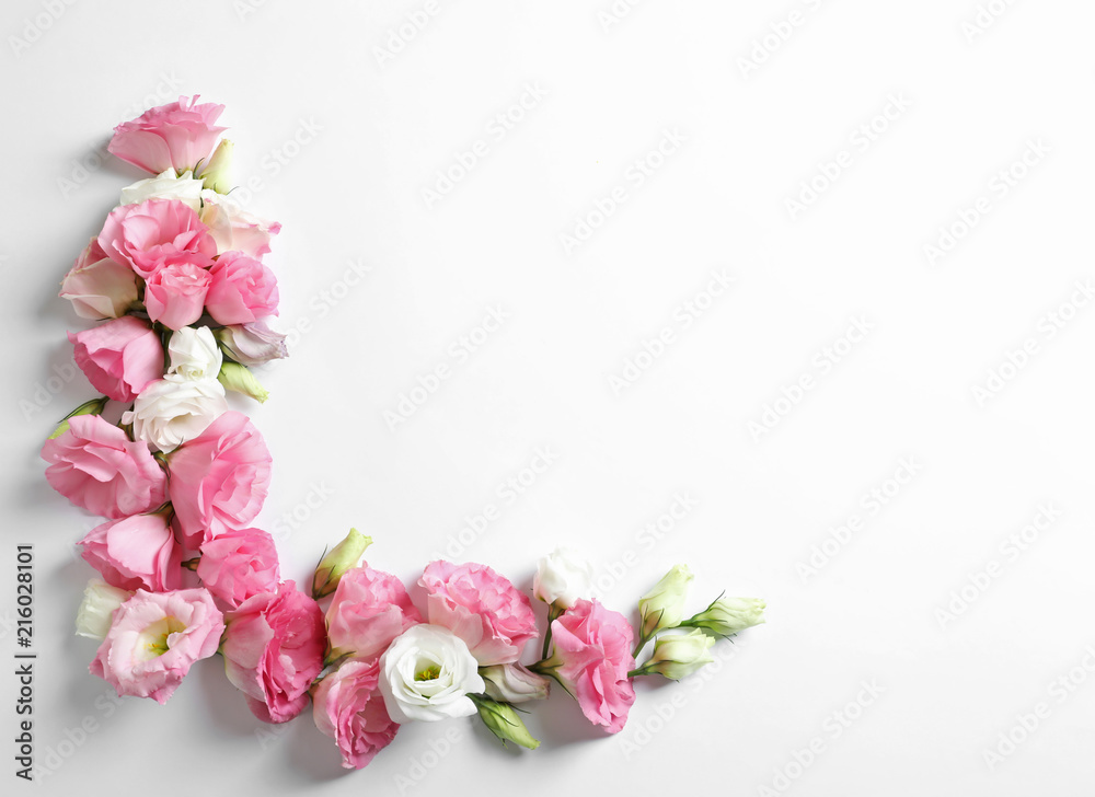 Flat lay composition with beautiful Eustoma flowers on light background