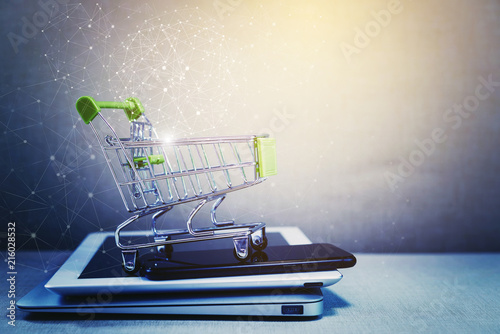 Online shopping background. E-commerce marketing technology, shopping cart on stacked mobile, tablet and laptop with connection line icon. Worldwide business. Global communication.