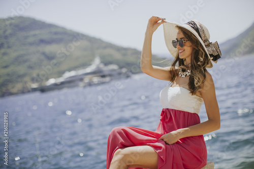 Pretty young woman by the sea