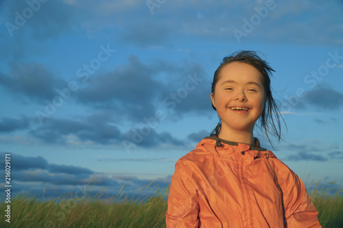 Portrait of little girl smiling on background of blue sky