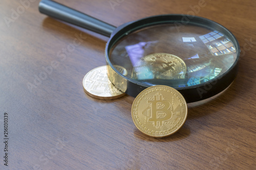 Magnifying Glass With Bitcoin Coins photo