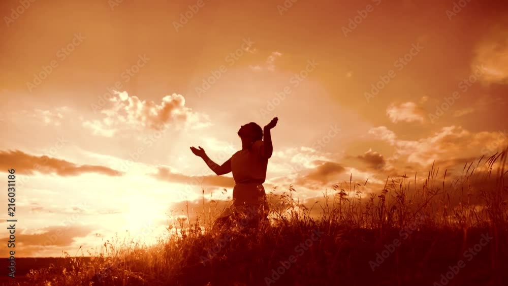 Praying Motion Girl folded her hands in prayer silhouette lifestyle at sunset. woman ...