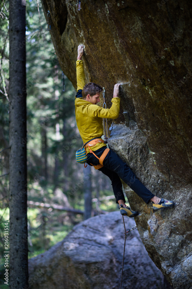 Male climber climbing overhanging rock,Outdoor active lifestyle
