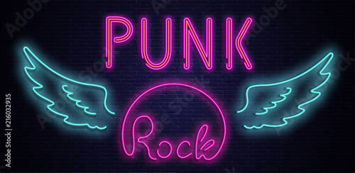 Punk rock neon colorful signboard on black bricklaying wall.