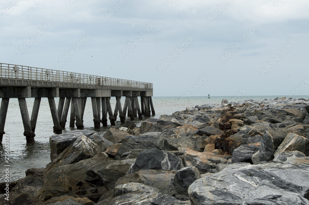 The fishing pier that parallels the jetty in Cocoa Beach, Florida. 