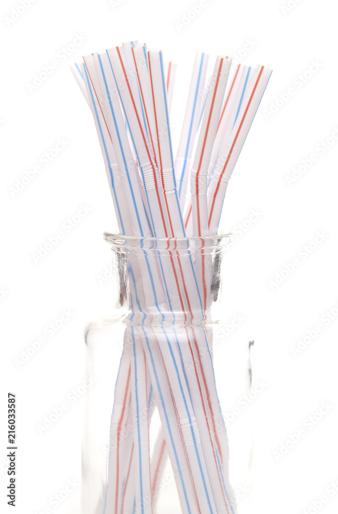 Bunch of Straws in a Glass Container on a White Background Bunch of Straws in a Glass Container on a White Background