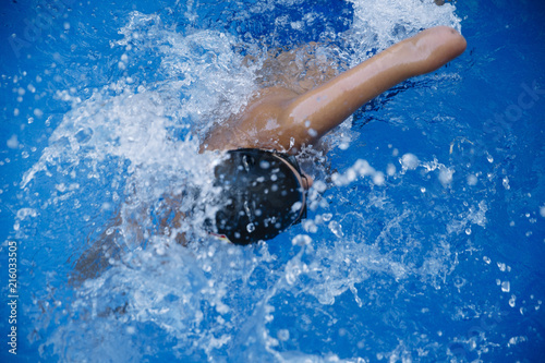 Young boy who does swimming and he lacks an arm, disabled person photo