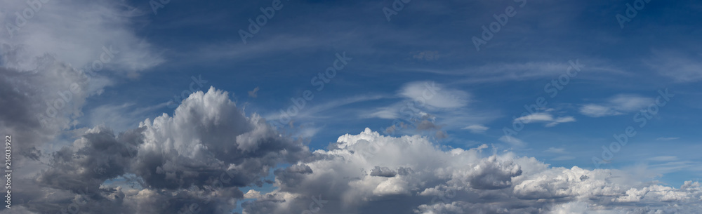 Beautiful blue sky with fluffy white clouds scattered across