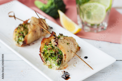 White fish roulades stuffed with broccoli and asparagus photo