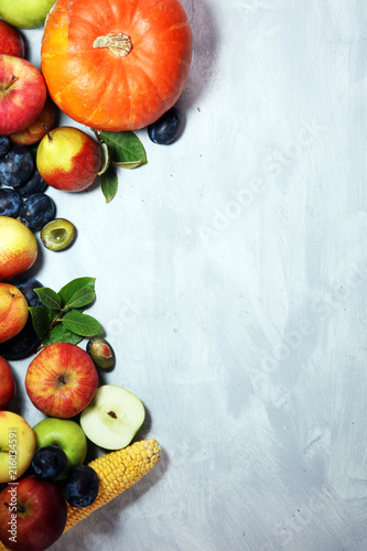 Various fresh fruits. Thanksgiving pumpkin  apples  and maize on rustic background.