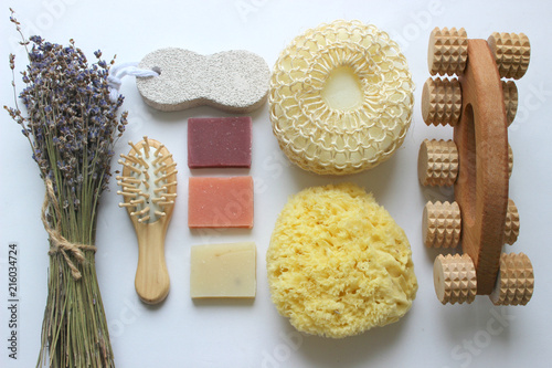 Spa accessories-sponge, natural soap, essential oil, pumice, salt, washcloth, comb, candles on a light background, top view. The concept of a healthy lifestyle. Beauty, skin care. flat position photo