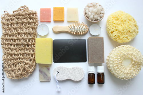 Spa accessories-sponge, natural soap, essential oil, pumice, salt, washcloth, comb, candles on a light background, top view. The concept of a healthy lifestyle. Beauty, skin care. flat position