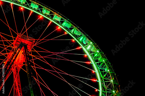 Big ferris wheel with festive green and red illumination