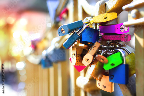 Extremely colourful set of Metal locks. A bunch of Heart fastened wedding locks on a european gate bridge. Love signs relations couples relationship , concept background shallow depth of field.