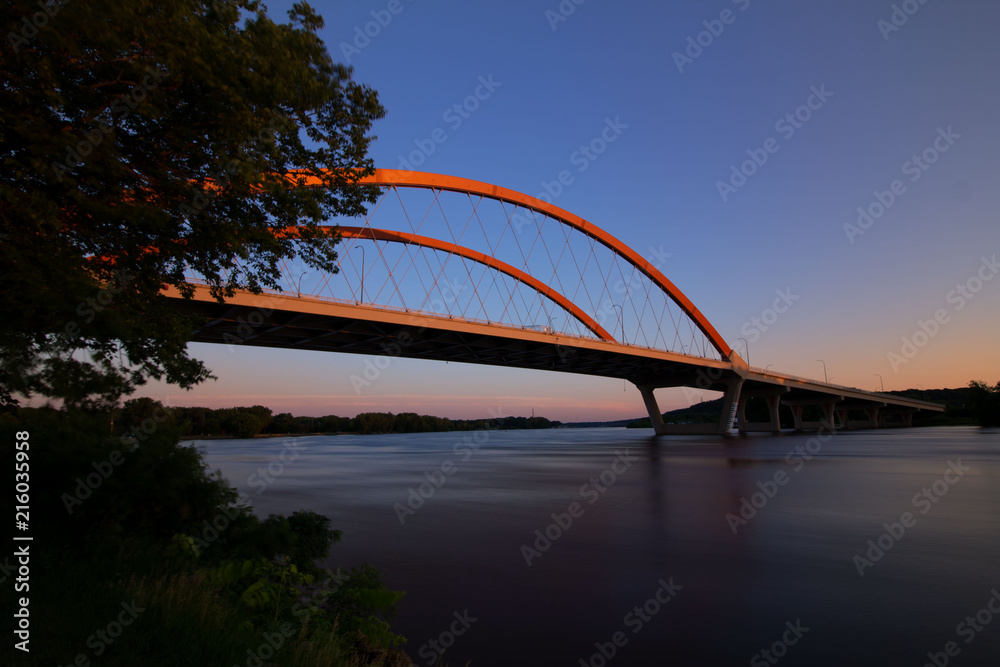 Hastings bridge spanning over the Mississippi River at dawn with the morning sunrise Hastings bridge spanning over the Mississippi River at dawn with the morning sunrise
