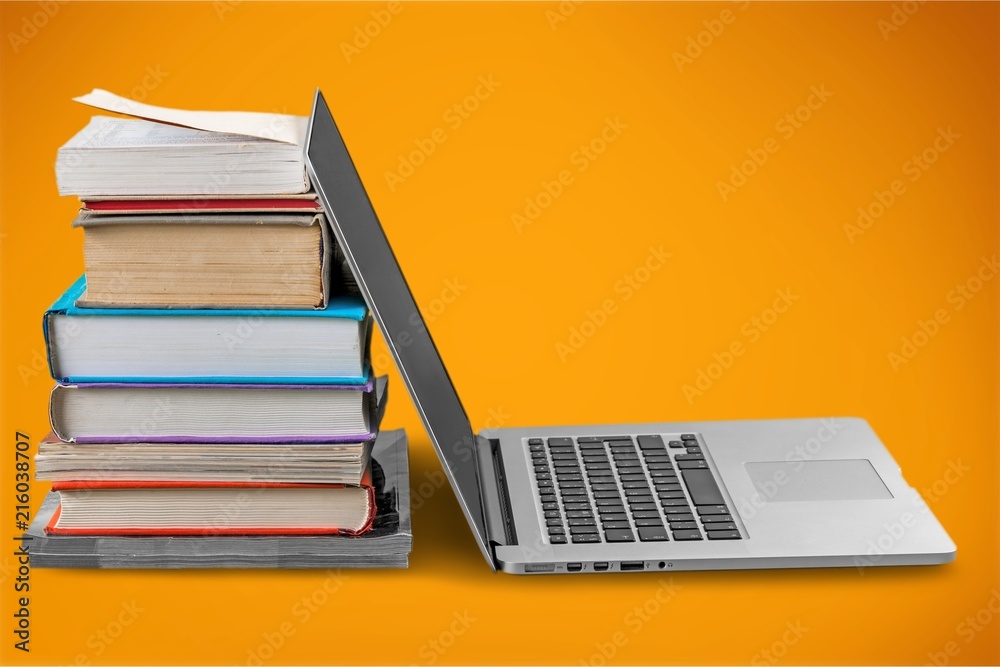 Stack of books with laptop on table Stack of books with laptop on table