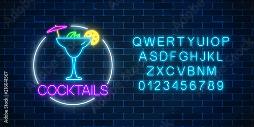 Neon sambuca cocktail sign in circle frame with alphabet. Glowing gas advertising with glass of alcohol shake.