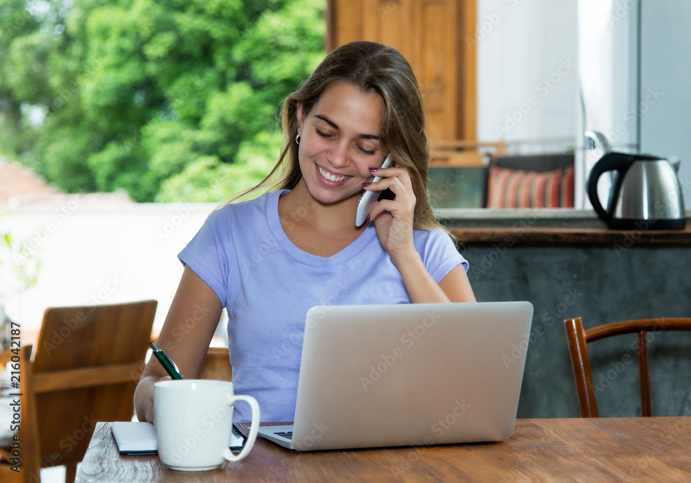 Blonde woman with computer working at home Blonde woman with computer working at home