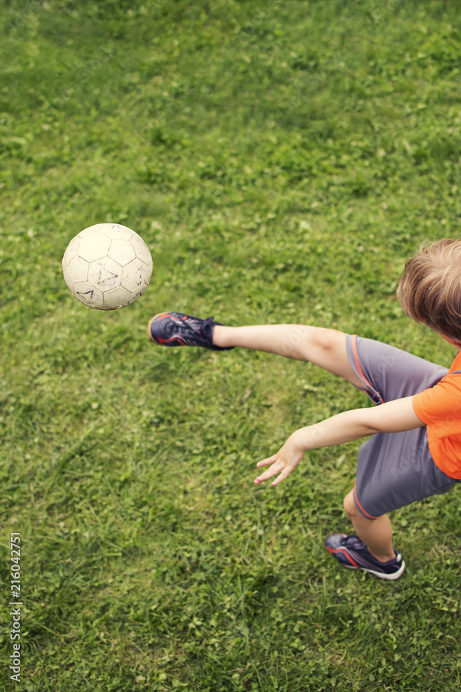 child soccer, strong kick with the ball. top view. bokeh child soccer, strong kick with the ball. top view. bokeh