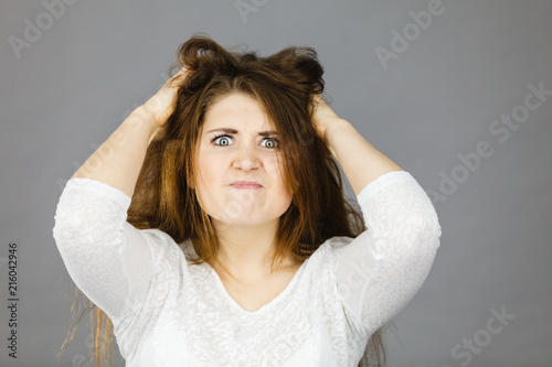 Attractive woman having angry frustrated face expression photo