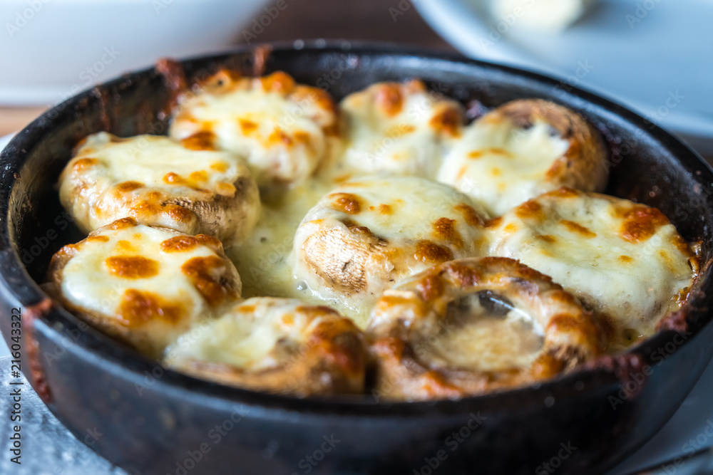 Stuffed mushrooms with cheese on the pot, Georgian cuisene Stuffed mushrooms with cheese on the pot, Georgian cuisene