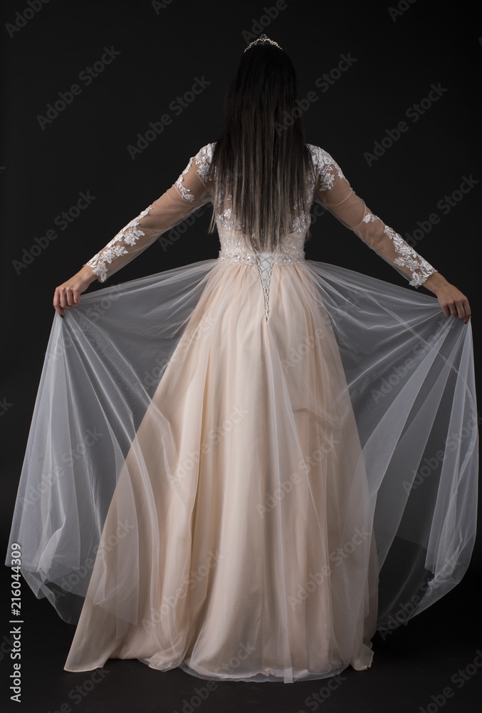 Full length of a beautiful bruenette woman in wedding dress