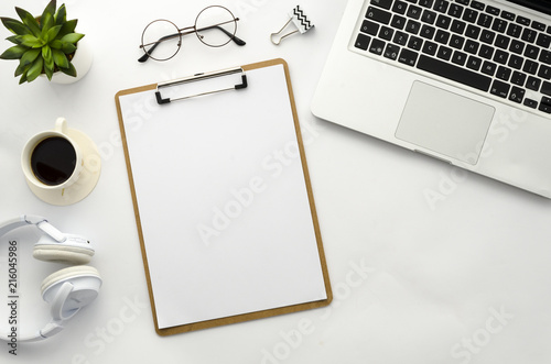 Clipboard mock up. Home office workspace flat lay mockup with clipboard  coffee  laptop  glasses and green plant. Flat lay  top view mockup.