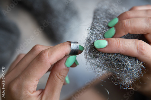 The process of making silver jewellery. Female artist hands close up. Crafting a silver ring, see the entire series. photo