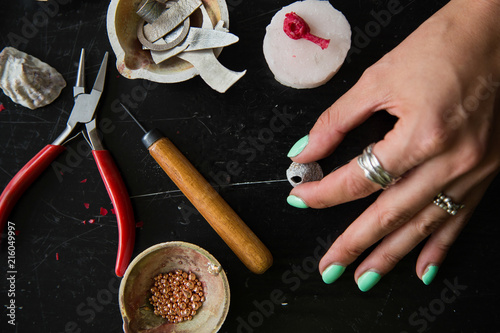 The process of moulding silver jewellery with natural objects like seashells with jeweller's wax