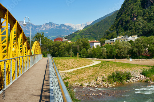 Drusus bridge in Bolzano passing river Talvera with the Dolomites Italian Alps on the background photo