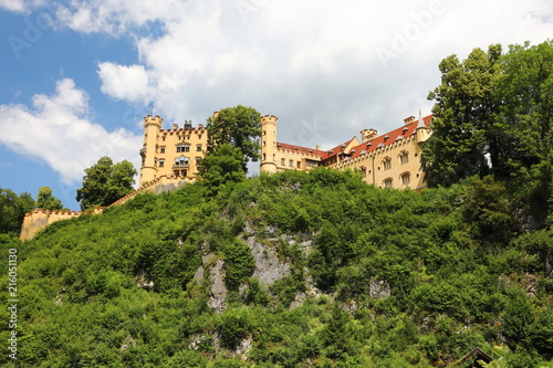 The picturesque foothills of the Alps, the lake surrounded with the low rocks overgrown with the dense wood are visible the old castle. © FEDORENKO