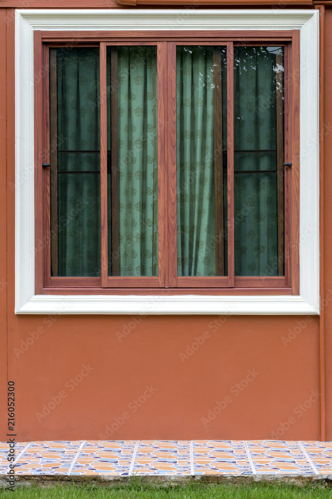Fototapeta premium Brown wood patterned window with concrete wall.