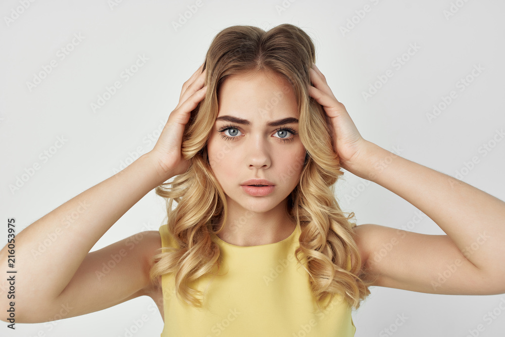 young blond woman on a light background portrait