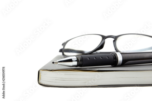 A black pen and empty open book on white background