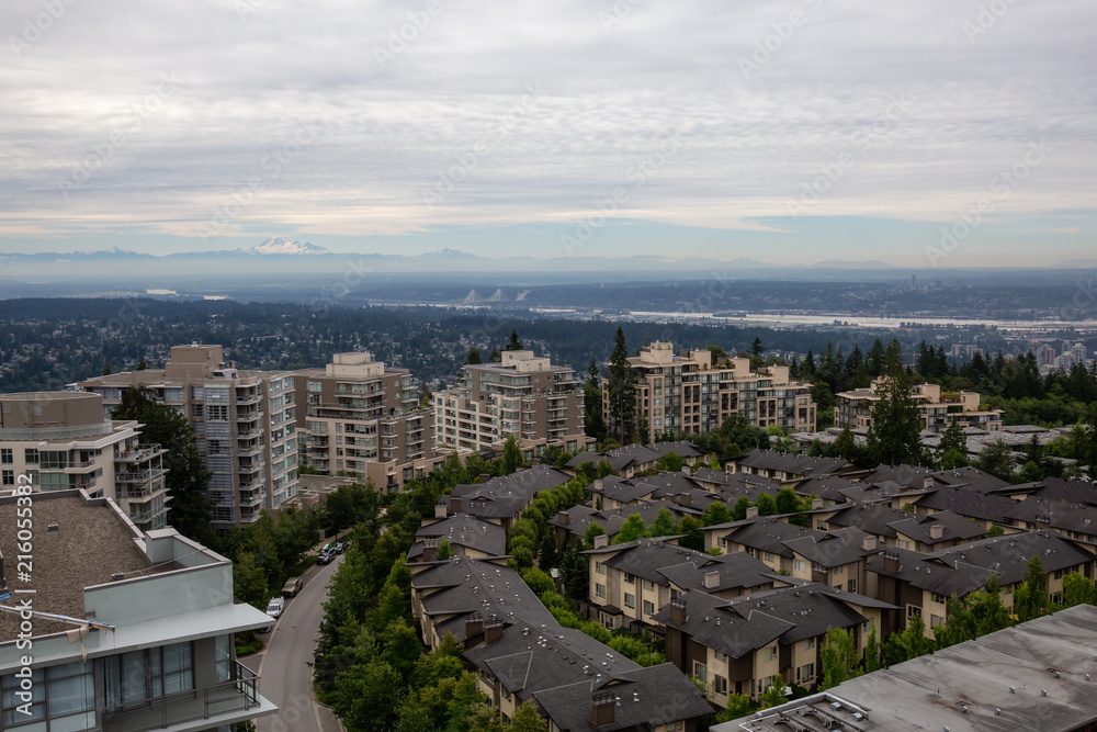 Aerial view of residential homes and buildings on top of Burnaby Mountain. Taken in Vancouver, British Columbia, Canada.